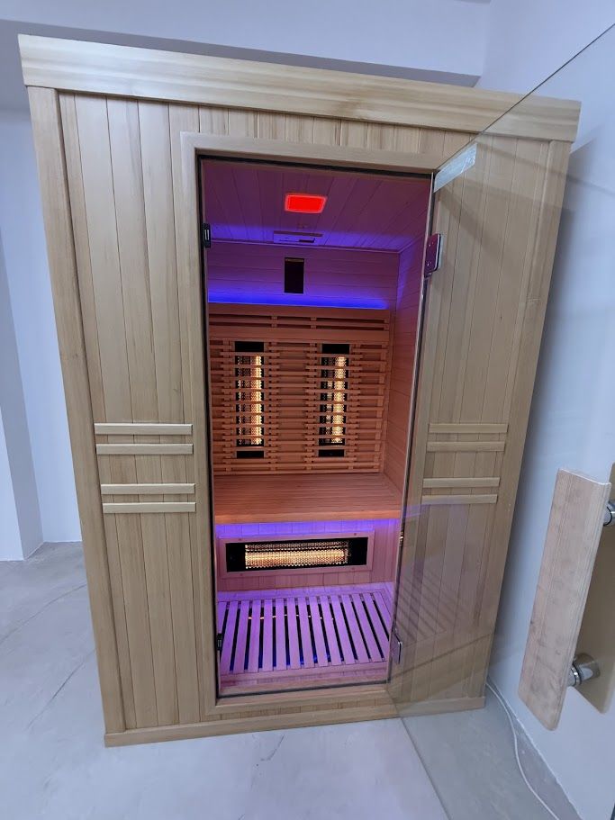 Infrared sauna cabin with emitters glowing
