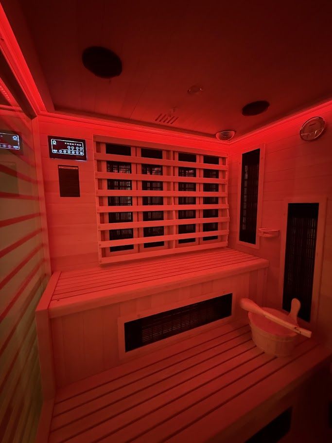 Hybrid sauna interior with infrared panels and red light